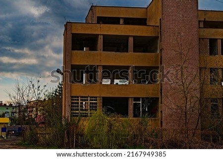 An old, concrete industrial building - a former production plant. A derelict and dilapidated building with empty 'eye sockets' of the windows.  Photo stock © 