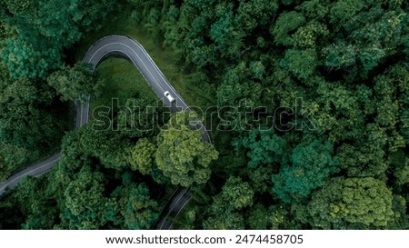 Similar – Image, Stock Photo Aerial view at the car traffic on a road between a forest in foggy conditions, nice misty view from the birds eye.