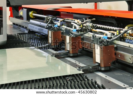 close up of cnc punching machine with metal plate