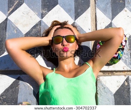 Summer fashion close up portrait Young hipster girl going crazy, have positive surprised emotions, sending kisses,bright summer outfit,mirrored sunglasses and big pink lips.