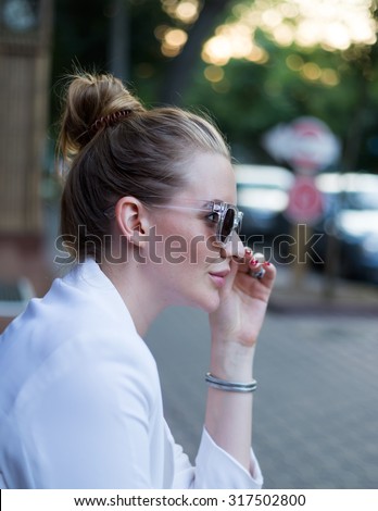 Autumn fashion close up portrait of young elegant lady wearing white jacket,dress and sunglasses.wearing trendy summer elegant outfit