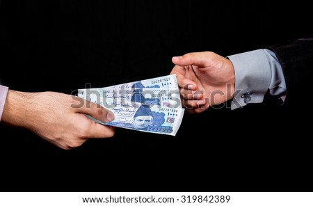 first person is giving 1000 Rupees Pakistani Currency Notes to another Person\
isolated with black background