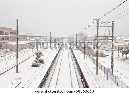 Railway track and station where snow piles