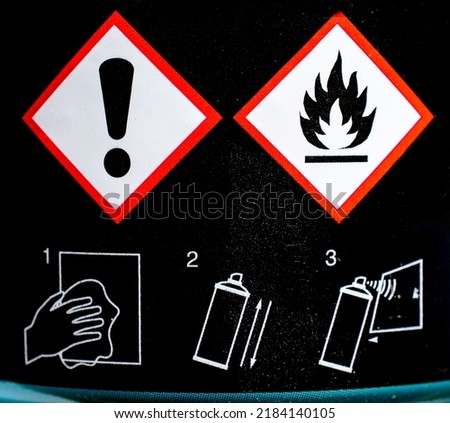 Caution and flammable signs on the paint bottle black surfaces. Open, shake, apply concept.  Foto stock © 