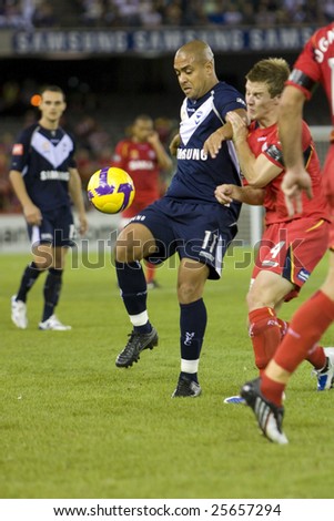 MELBOURNE - FEBRUARY 14: A-league Major Semi Final - Melbourne Victory 4 defeat Adelade United 0. Ney Fabiano trying to control the ball under pressure on February 14, 2009 in Melbourne.