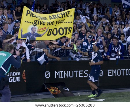 MELBOURNE - FEBRUARY 28: A-league Major Grand Final - Melbourne Victory defeat Adelaide United 1-0 on February 28, 2009 in Melbourne, Australia. Archie Thompson gives one of his boots to a fan.