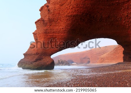 Red archs on atlantic ocean coast. Morocco