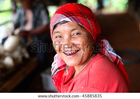 AKHA HILL TRIBE VILLAGE, THAILAND - AUG 24: Akha hill tribe woman with black teeth smiles  August 24, 2007 in Akha hill tribe village, Thailand.