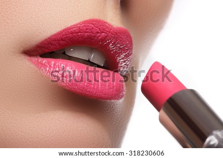 Woman painted pink lips. Beauty lips make-up. Perfect skin, full lips. Retro make up. Professional make-up artist applying sexy lips makeup. Fashion makeup