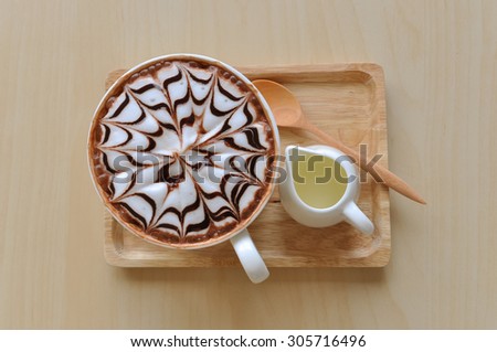 Hot chocolate with syrup on the wood tray ,selective focus point.