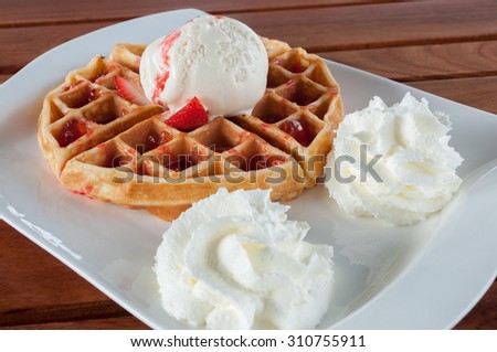 Waffle with Ice cream , strawberry and whipping cream,selective focus point.