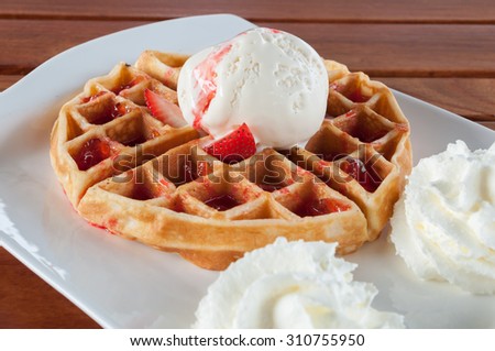 Waffle with Ice cream , strawberry and whipping cream,selective focus point.