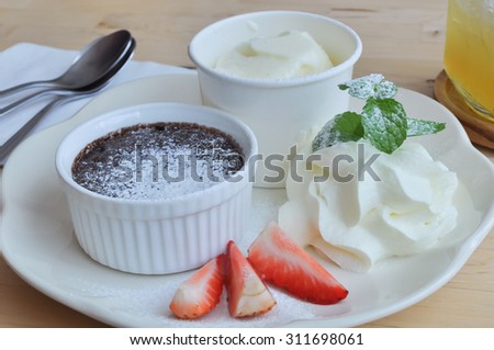 Chocolate lava set with fresh strawberry ,vanilla ice cream and whipping cream , selective focus point.