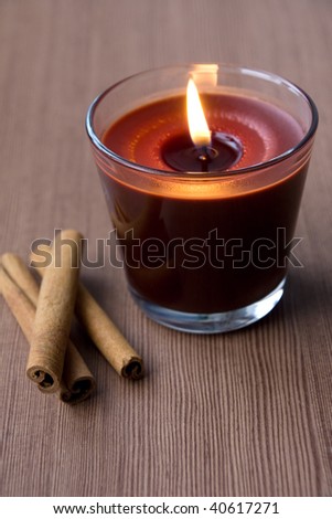 Candle in the glass and cinnamon sticks