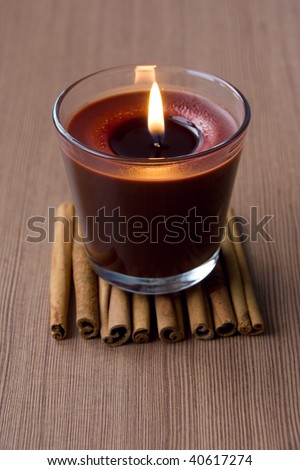 Candle in the glass and cinnamon sticks