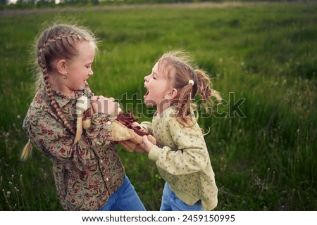 Similar – Image, Stock Photo Two little girls play on rocky northern seashore. Sit, laugh, hug, explore the coastal rocks. Travel and enjoy a great adventure in Norway. Beautiful view of fjord and mountains in sunset.