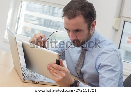 Businessman looking at tablet computer at the office