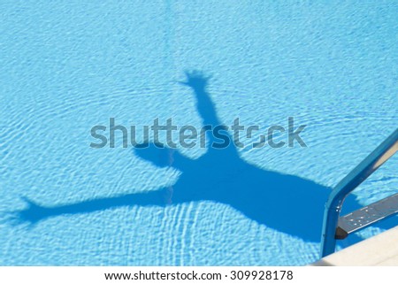Human shadow in the swimming pool