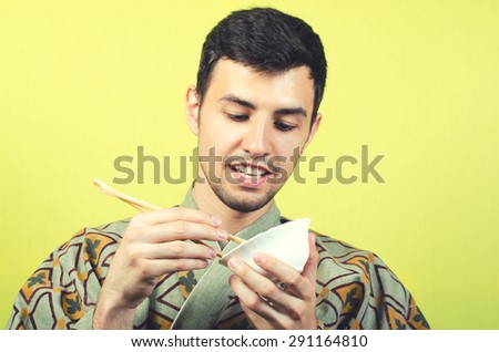 man wearing kimono eating