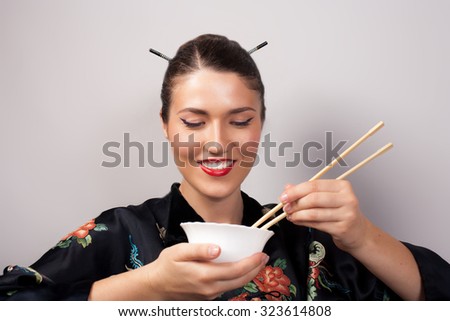 woman in kimono eating rice using chinese chopsticks
