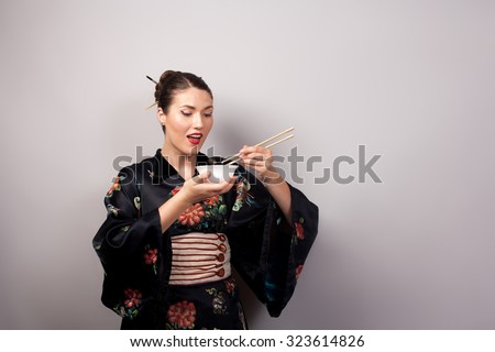 woman in kimono eating rice using chinese chopsticks