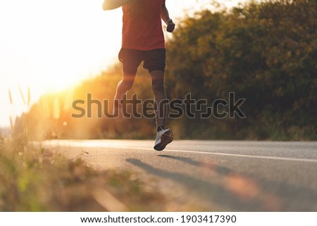 Similar – Image, Stock Photo Athlete runner feet running on treadmill closeup on shoe. Workout and diet concept.