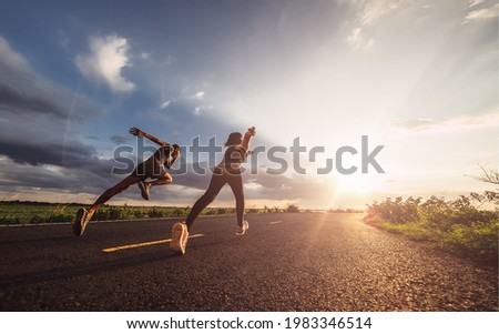 Young couples running sprinting at sunset times. Fit runner fitness runner during outdoor workout.