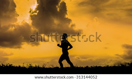 silhouette of a jogger in sunset