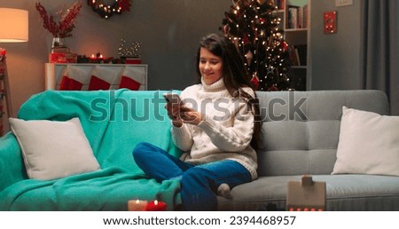 Similar – Image, Stock Photo Young woman in christmassy clothes looks smiling at a christmas present