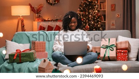 Similar – Image, Stock Photo Young woman in christmassy clothes looks smiling at a christmas present