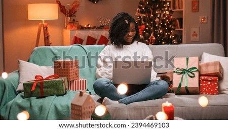 Similar – Image, Stock Photo Young woman in christmassy clothes looks smiling at a christmas present