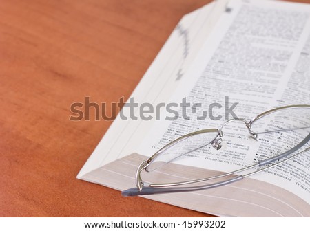 office table with book and eyeglasses
