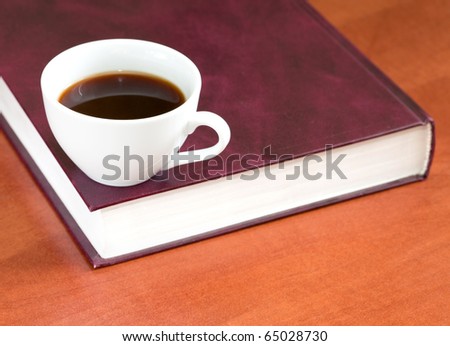 Coffee and book on a wooden table