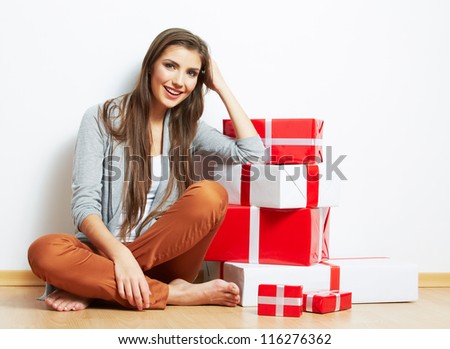 Woman portrait in christmas style with red, white box gift seat, isolated on white background.