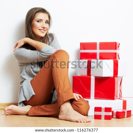 Woman portrait in christmas style with red, white box gift seat, isolated on white background.