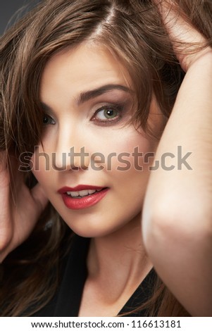 Close up portrait of beautiful young woman face. Isolated on gray background. Portrait of a female model.