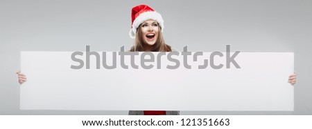 Christmas Santa hat isolated woman portrait. Female smiling model hold white blank board.