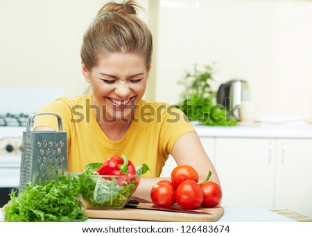 Laughing woman portrait in kitchen.