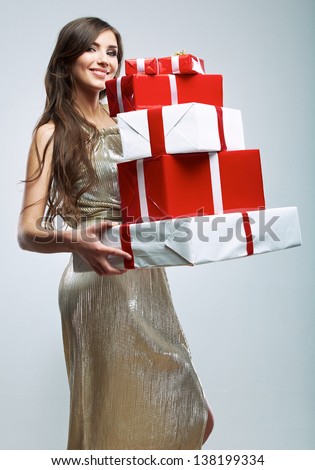 Young woman hold many red, white gift box . Female model isolated against studio background.