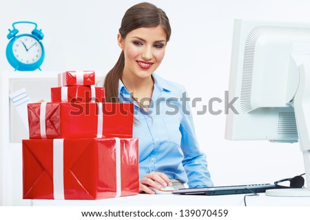 Business woman at work in office. Red gift box on table. Female business model.