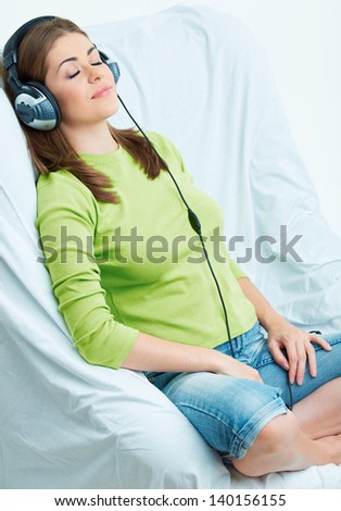 Young woman listening music in headphones. Female relaxing model.