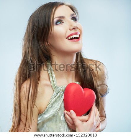 Red heart. Love symbol. Portrait of beautiful woman hold Valentine day symbol. Isolated studio background female model.