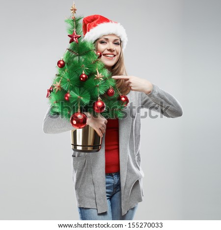 Santa girl hold christmas tree. Isolated portrait.