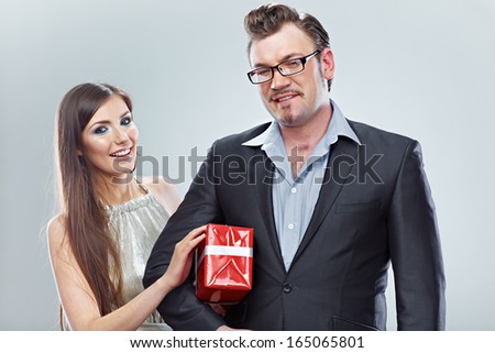 Business couple. Isolated. Man hold gift. White background.