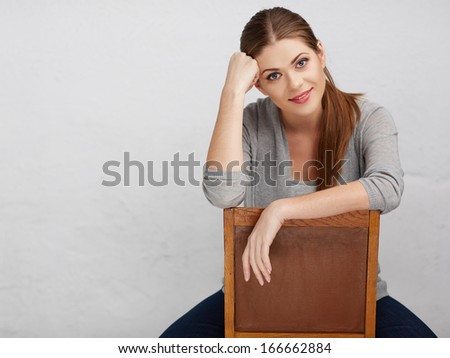 Woman sitting on chair , beautiful model . Chair back . Isolated .