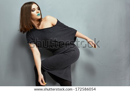 Fashion photo of young model. Black dress. Woman body.