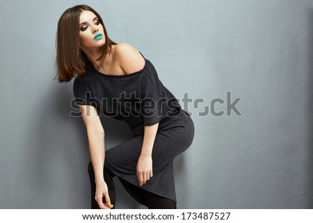 Fashion model black dress posing. Young woman grunge style fashion photo. Studio.