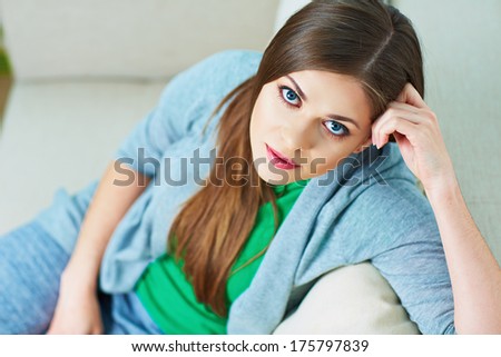 Woman relax on couch at home. Beautiful girl portrait.