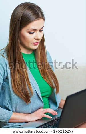 Woman working at home. Computer, laptop. Young female model.