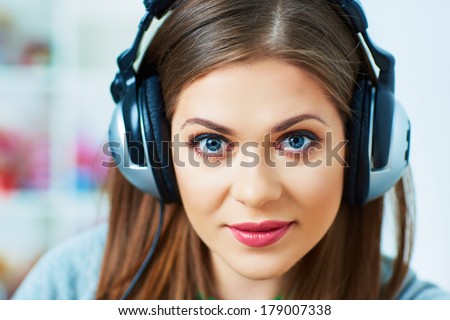 Young woman portrait with headphones music listening. Beautiful girl.